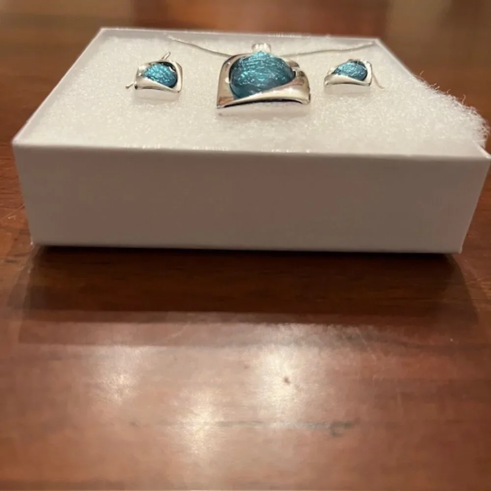 Aqua blue glass pendant and silver tone chain with matching earrings